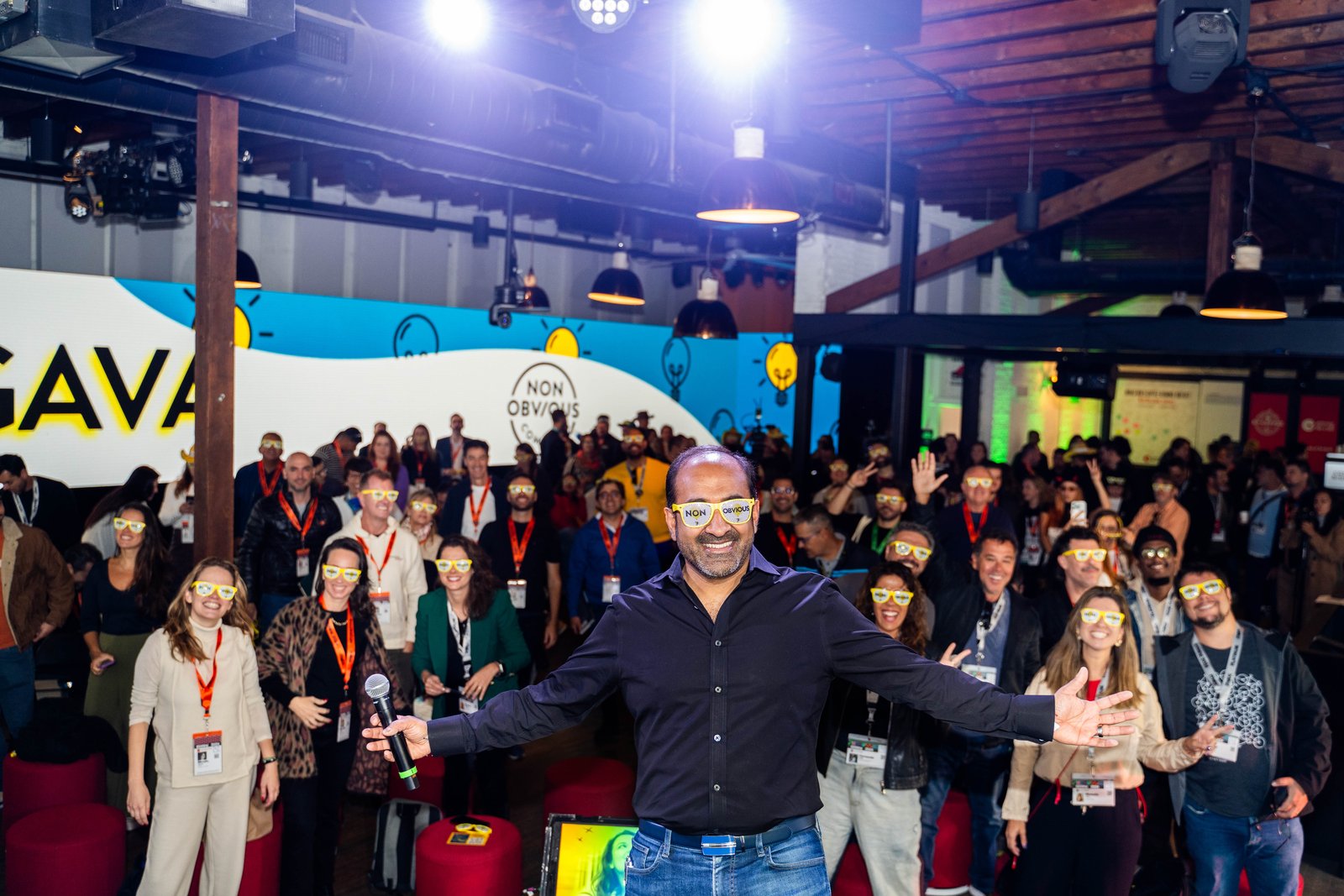 A group wearing the yellow Non-Obvious glasses at a Non-Obvious event